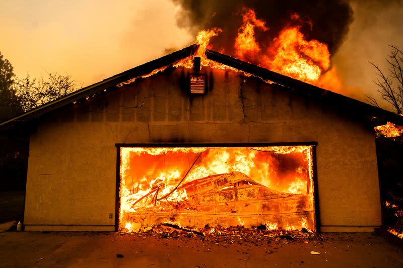 Flames consume a garage as the Thompson Fire burns in Oroville, Calif., Tuesday, July 2, 2024. An extended heat wave blanketing Northern California has resulted in red flag fire warnings and power shutoffs. | Noah Berger