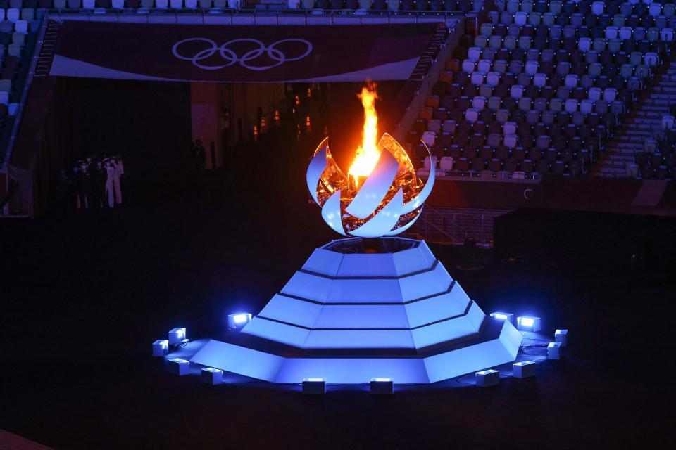 <p>A view shows the Olympic Cauldron and the Olympic flame during the closing ceremony of the Tokyo 2020 Olympic Games, on August 8, 2021 at the Olympic Stadium in Tokyo. (Photo by Behrouz MEHRI / AFP) (Photo by BEHROUZ MEHRI/AFP via Getty Images)</p> 