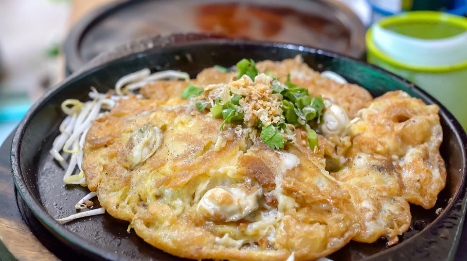 omelette with onions on black plate