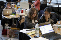 FILE - In this Jan. 29, 2017, file photo, volunteer lawyers work to help free travelers detained at John F. Kennedy International Airport during President Donald Trump's order to temporarily ban refugees and citizens from seven Muslim-majority countries from traveling to the U.S., in New York. Trump appears to be ignoring a deadline to establish how many refugees will be allowed into the U.S. in 2021, raising uncertainty about the future of the 40-year-old resettlement program. The 1980 Refugee Act requires presidents to issue their determination before Oct. 1, 2020, the start of the fiscal year. (AP Photo/Seth Wenig, File)