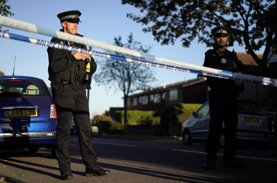 Police officers block one of the roads leading to the Belfairs Methodist Church in Eastwood Road North, where British Conservative lawmaker David Amess has died after being stabbed at a constituency surgery, in Leigh-on-Sea, Essex, England, Friday, Oct. 15, 2021. Police gave no immediate details on the motive for the killing of 69-year-old Conservative lawmaker Amess and did not identify the suspect, who was being held on suspicion of murder. (AP Photo/Alberto Pezzali)