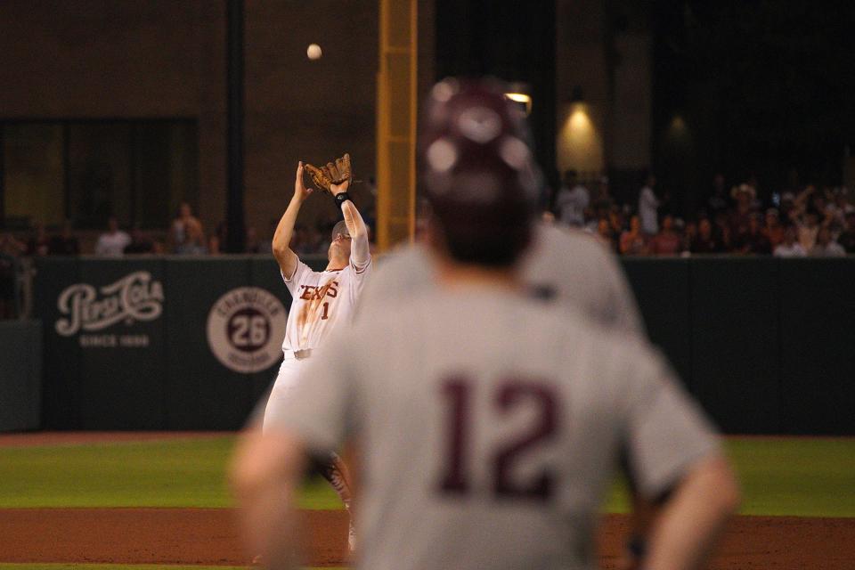 Texas Longhorns infielder Jalin Flores (1) catches a fly ball hit by the Texas A&M Aggies during the second round in the NCAA baseball College Station Regional on June 1, 2024 at Olsen Field College Station.