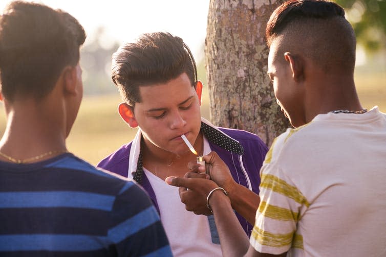 Teenagers smoking cigarettes