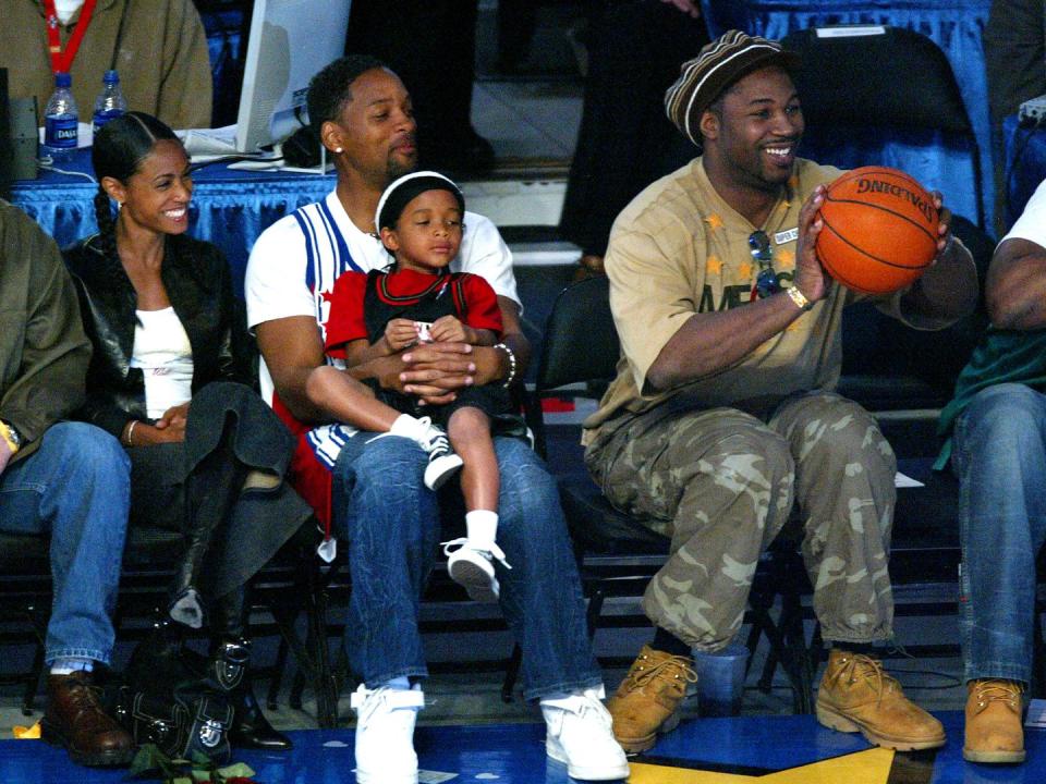 <p>Will Smith and Jada Pinkett Smith take their son Jaden to the 2004 NBA All-Star slam-dunk contest in L.A. (Boxer Lennox Lewis sits to the right.)</p>