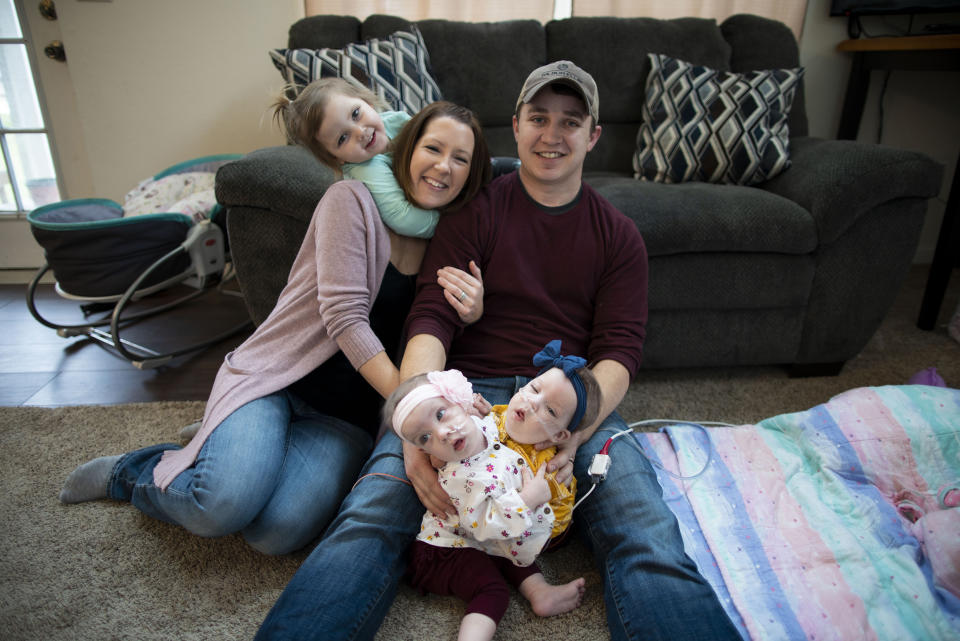 Alyson and Phil Irwin with their daughters, twins, Amelia and Sarabeth, and big sister Kennedy who is almost 4. (Joe Hallisy / Michigan Medicine)