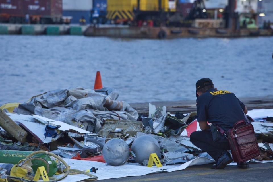 <div class="inline-image__caption"><p>A forensic investigator looks through the remains of Lion Air flight 610 at the Tanjung Priok port in Jakarta, Indonesia. </p></div> <div class="inline-image__credit">Ed Wray/Getty</div>