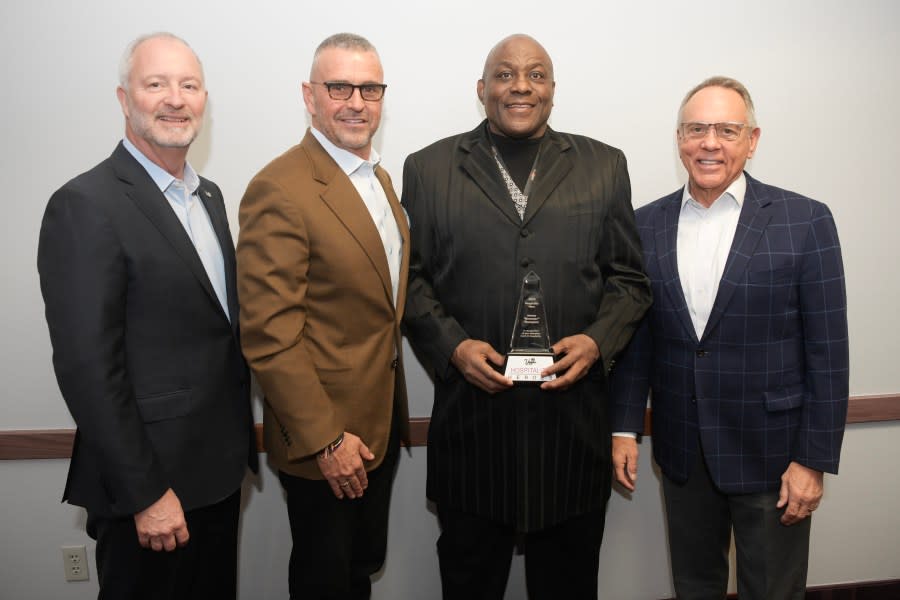 Hospitality Hero award recipient Brewster Thompson poses with, from left, LVCVA CEO and President Steve Hill, LVCVA Board of Directors Vice Chairman Anton Nikodemus, and LVCVA Board of Directors Chairman Jim Gibson, right, during the monthly meeting of the LVCVA Board of Directors Tuesday, November 14, 2023, at the Las Vegas Convention Center in Las Vegas, Nevada. (Sam Morris, LVCVA Archive)