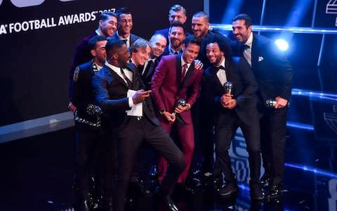 Idris Elba poses with members of the team winning the FIFA FIFPro World11 award - Credit: AFP