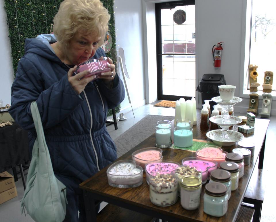 Charlotte Roberts of Monroe shops for candles at a recent pop-up shop hosted at Monroe Nutrition, 739 S. Monroe St.