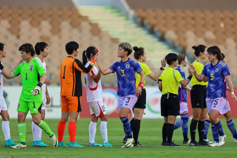 Players shake hands after North Korea and <a class="link " href="https://sports.yahoo.com/soccer/teams/japan/" data-i13n="sec:content-canvas;subsec:anchor_text;elm:context_link" data-ylk="slk:Japan;sec:content-canvas;subsec:anchor_text;elm:context_link;itc:0">Japan</a> drew 0-0 in the first leg of their women's Olympic qualifier in Jeddah (Abdel Ghani BASHIR)