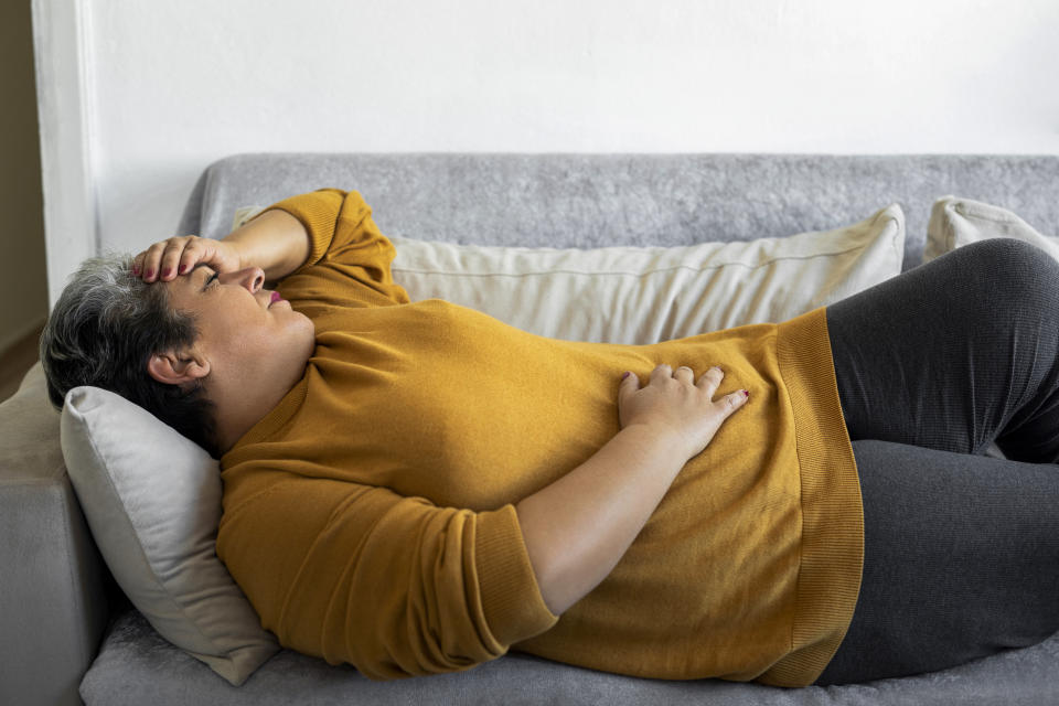 Pain and cramps during menopause. The Menopause Foundation of Canada found that although many people knew about hot flashes and night sweats, the majority of women did not know that urinary tract infections, heart palpitations and pain during intercourse were also symptoms. (Image via Getty)