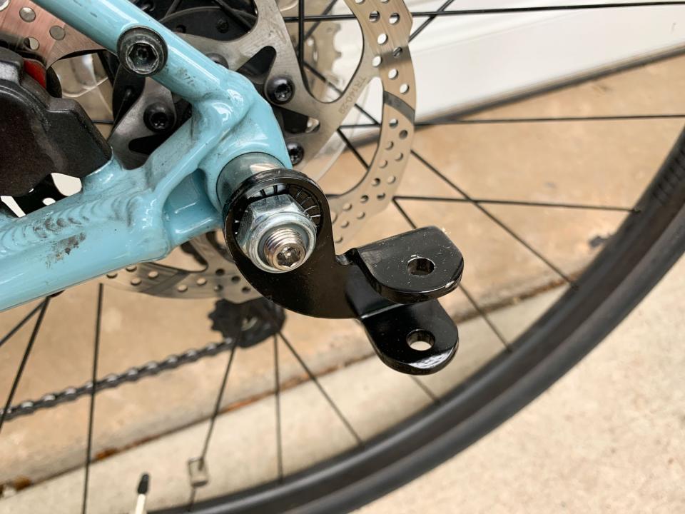 Burley's D'Lite X connects to a bike with a bracket