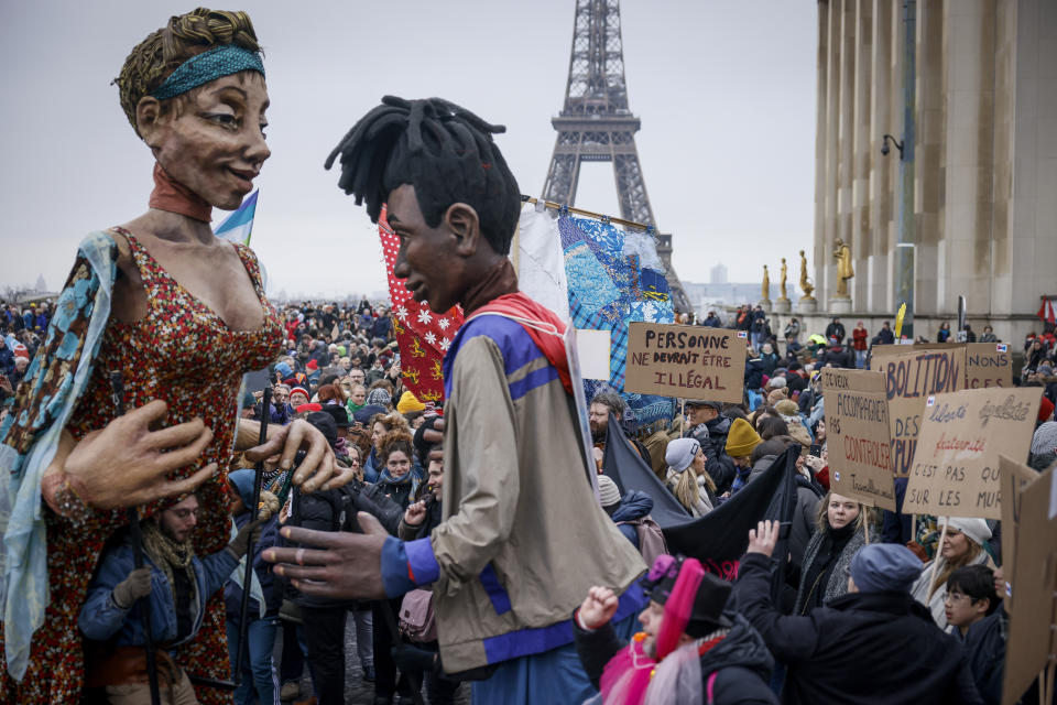 Opponents of France's immigration law carry models of migrants at Trocadero Plaza near Eiffel Tower during a protest in Paris, Sunday, Jan. 21, 2024. The Constitutional Council is reviewing next week the government's controversial immigration law, to check that measures is in line with the Constitution. (AP Photo/Thomas Padilla)