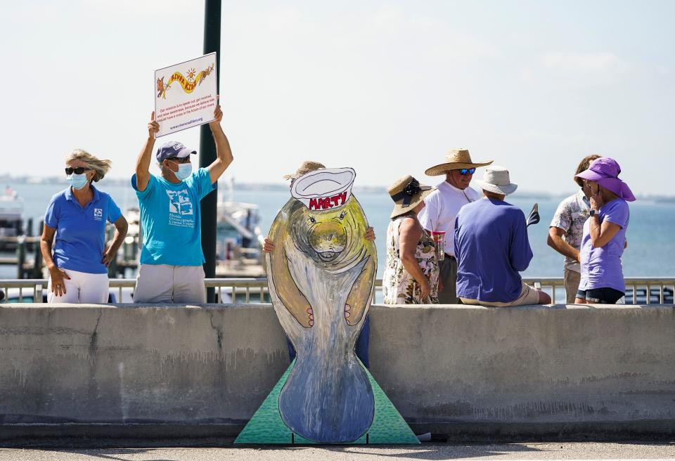 Concerned citizens gather on the Ernest Lyons Bridge for the Rally for the Manatees on Saturday, May 1, 2021, in Stuart. Organized by the RiverKidz, the event aimed to bring awareness to the 670 manatees deaths in 2021 and the decline in seagrass habitat.