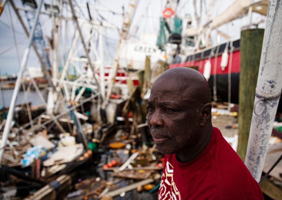 Kenny Washington has been shrimping for decades.  He survived Hurricane Ian by jumping off the Perseverance, behind him, to the Green Flash, upper center.  