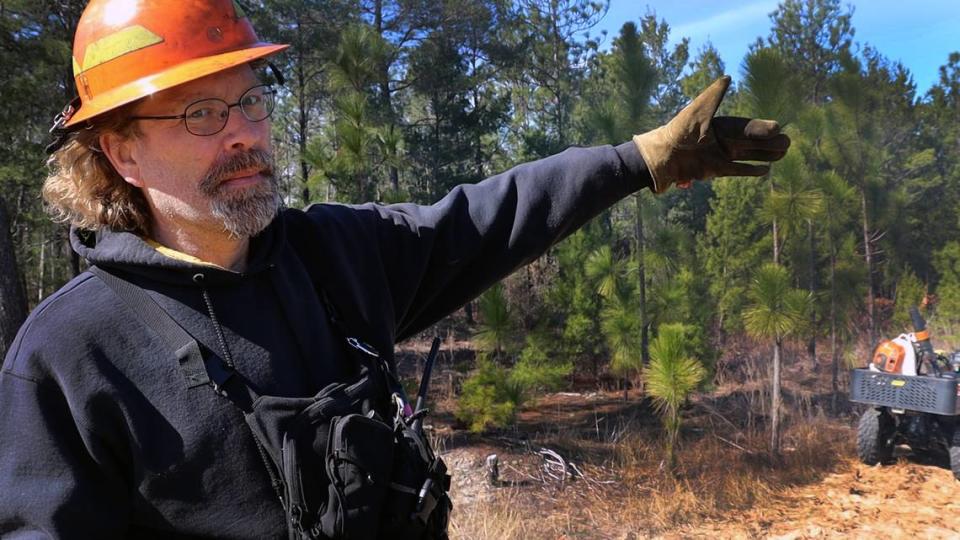 Nathan Klaus, Senior Wildlife Biologist for the Georgia DNR explaining the important of starting the burn on the perimeter. The native long-leaf pine, behind Klaus, is thriving at Sand Hill Wildlife Management Area and protected through fire.