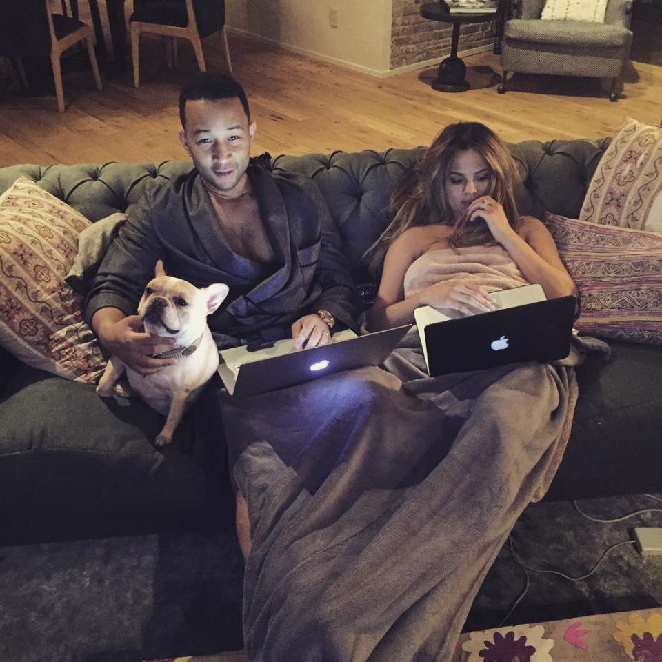 Chrissy Teigen and husband John Legend relaxing at home, with caption: 