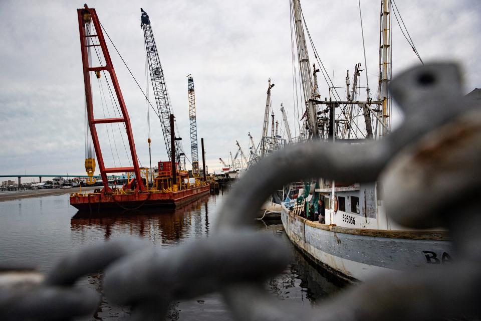 In late December, cranes with Resolve Marine have started arriving at the shrimp docks on Fort Myers Beach to start putting shrimp boats back in the water that were washed ashore by storm surge associated with Hurricane Ian. On the right, working on the Babe, is Jesse Clapham, the fleet manager for Erickson & Jensen Shrimp Packers. A crew with another crane company helped move a few boats.