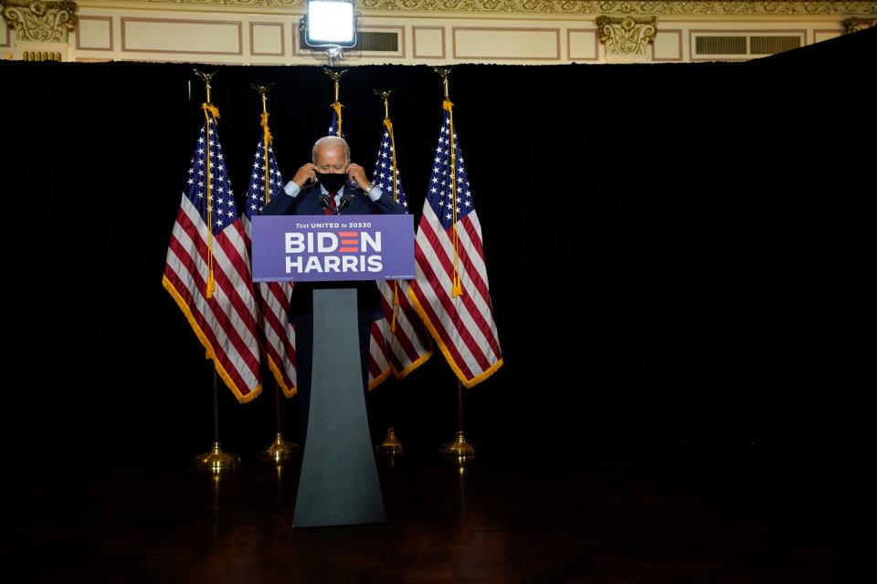 Democratic presidential candidate former Vice President Joe Biden removes his face mask to speak at the Hotel DuPont in Wilmington, Del., Thursday, Aug. 13, 2020. (AP Photo/Carolyn Kaster)