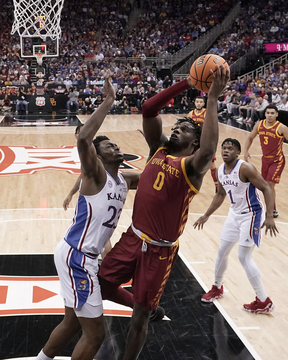 Iowa State forward Tre King (0) shoots over Kansas center Ernest Udeh Jr. (23) during the first half of an NCAA college basketball game in the semifinal round of the Big 12 Conference tournament Friday, March 10, 2023, in Kansas City, Mo. (AP Photo/Charlie Riedel)