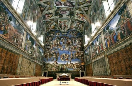 Newly installed tables stand under Michaelangelo's frescoes in the Vatican's Sistine Chapel before next week's conclave April 16, 2005.