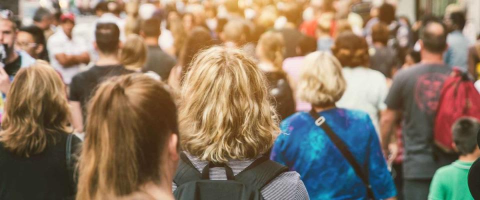 Unrecognizable mass of people walking in the city