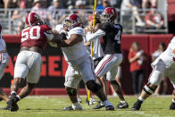 Alabama quarterback Jalen Milroe (4) looks for a receiver as offensive lineman Roq Montgomery (55) blocks defensive lineman Tim Smith (50) during the team's A-Day NCAA college football scrimmage Saturday, April 13, 2024, in Tuscaloosa, Ala. (AP Photo/Vasha Hunt)