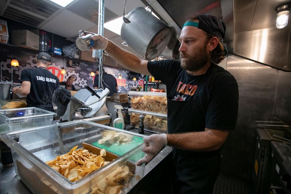 Co-owner Max Curtis prepares a bucket of homemade corn chips at Taco Works in Cape Coral.