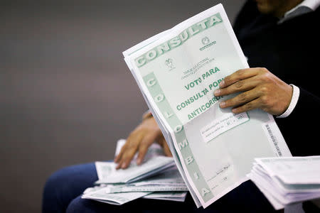 Electoral officials count ballots after tables closed during the seven-question referendum on anti-corruption measures in Bogota, Colombia August 26, 2018. REUTERS/Luisa Gonzalez