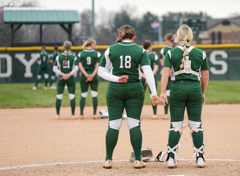 Pendleton Heights seniors Eliza Findlay (18) and Sydney Clark (11) hold hands during the National Anthem on Friday, March 31, 2023.