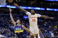 New Orleans Pelicans guard CJ McCollum (3) shoots against Atlanta Hawks center Clint Capela (15) during the first half of an NBA basketball game in New Orleans, Tuesday, Feb. 7, 2023. (AP Photo/Matthew Hinton)