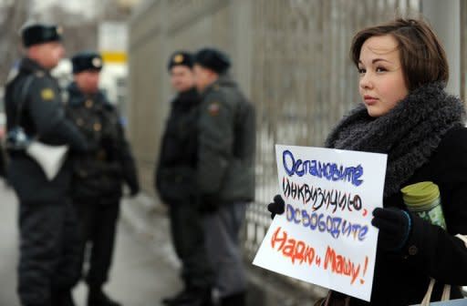 One of the supporters of a female Russian punk band Pussy Riot holds a poster as she pickets outside a Moscow courthouse. Russia has refused to free from pre-trial detention two members of female opposition punk rock group Pussy Riot who face up to seven years in jail for performing in a church