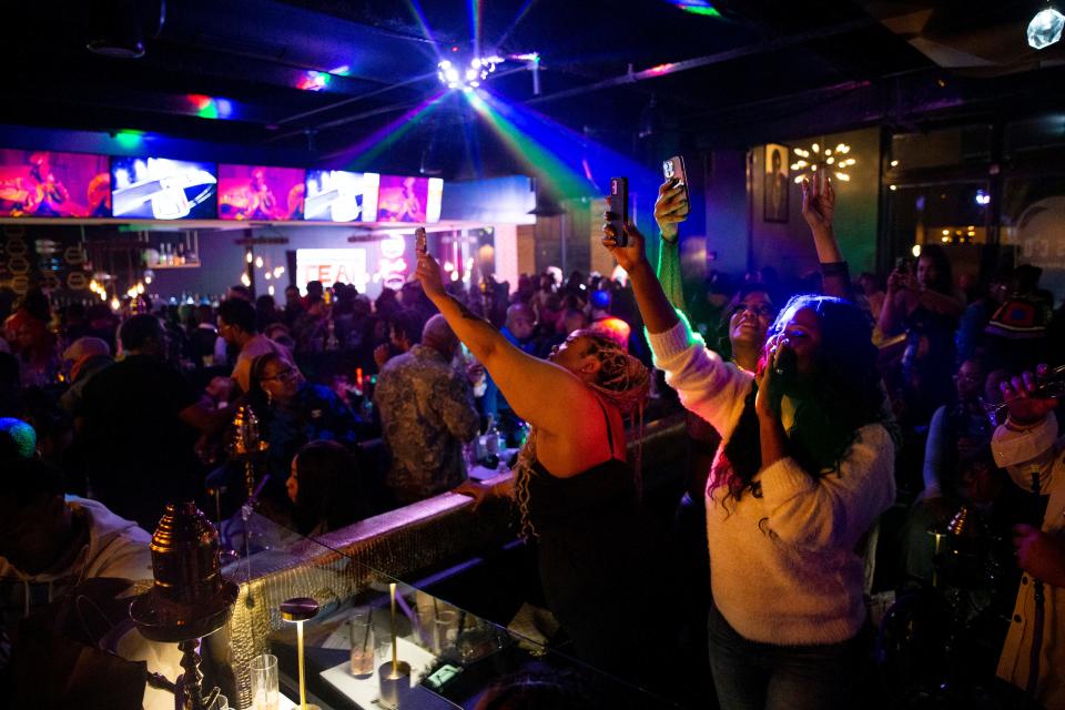 Attendees dance and take photos of rapper 2 Chainz as he sits in his reserved area during the opening celebration for Esco Restaurant and Tapas in Downtown Memphis, on Saturday, December 16, 2023.