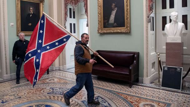 PHOTO: FILE - A supporter of US President Donald Trump carries a Confederate flag as he protestS in the US Capitol Rotunda, Jan. 6, 2021, in Washington, DC. (Saul Loeb/AFP via Getty Images, FILE)