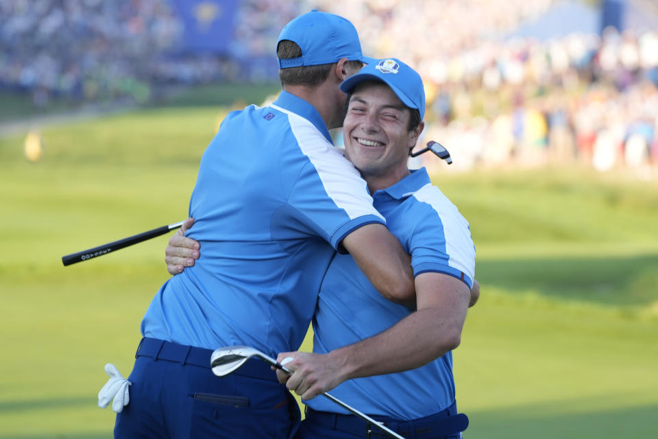 Europe's Viktor Hovland, right celebrates with playing partner Europe's Ludvig Aberg after winning the first hole during their morning Foursome match at the Ryder Cup golf tournament at the Marco Simone Golf Club in Guidonia Montecelio, Italy, Friday, Sept. 29, 2023. (AP Photo/Gregorio Borgia )