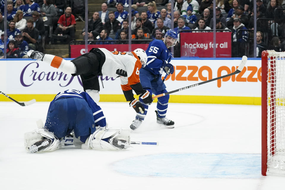 Philadelphia Flyers left wing Joel Farabee (86) jumps over Toronto Maple Leafs goaltender Ilya Samsonov (35) during the first period of an NHL hockey game Thursday, Feb. 15, 2024, in Toronto. (Arlyn McAdorey/The Canadian Press via AP)