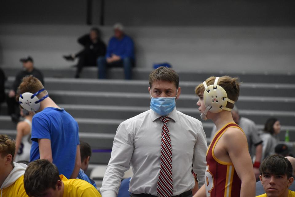 Mater Dei coach Greg Schaefer (left) gives advice to his son, Isaiah, the Wildcats' 106-pounder.