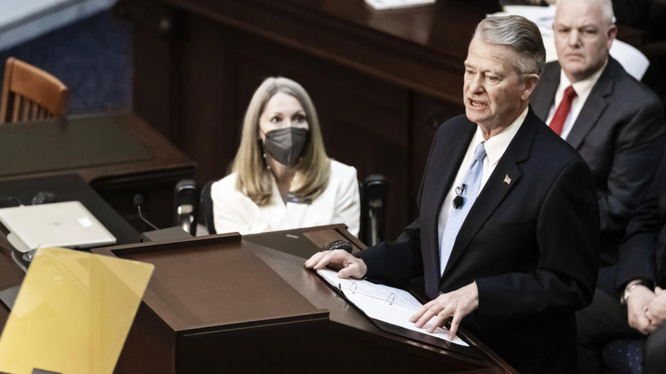 Idaho Gov. Brad Little, with a ring file open in front of him, delivers his State of the State address in the House chambers in Boise..