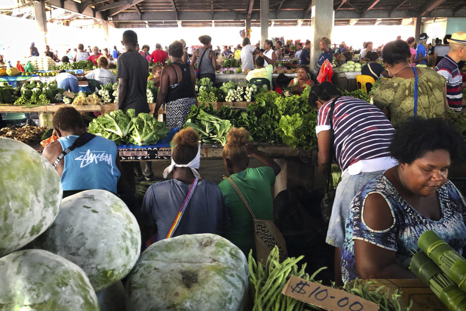 In this Nov. 24, 2018, photo, customers shop for vegetables at the Honiara Central Market in Honiara, the capital of the Solomon Islands. The Solomon Islands switched diplomatic recognition from Taiwan to China on Monday, Sept. 16, 2019, becoming the latest country to leave the dwindling Taiwanese camp.(AP Photo/Mark Schiefelbein)