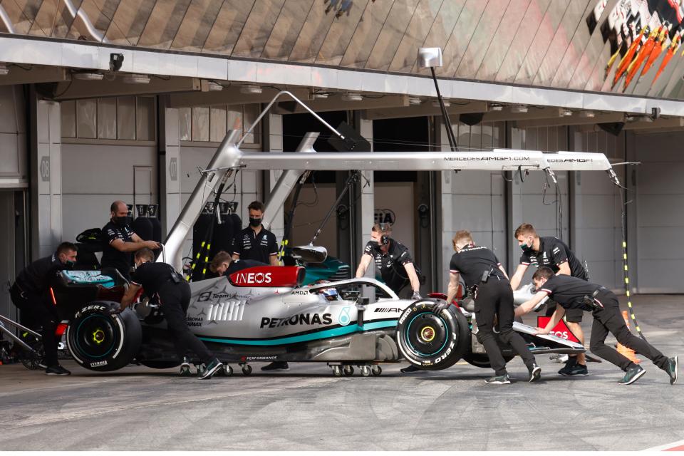 Mechanics move the car of Mercedes driver George Russell (AP)