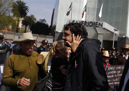 Andres Manuel Lopez Beltran, the son of leftist leader Andres Manuel Lopez Obrador, is greeted by a supporter during a protest against an energy reform bill at the Senate building in Mexico City December 4, 2013. REUTERS/Tomas Bravo