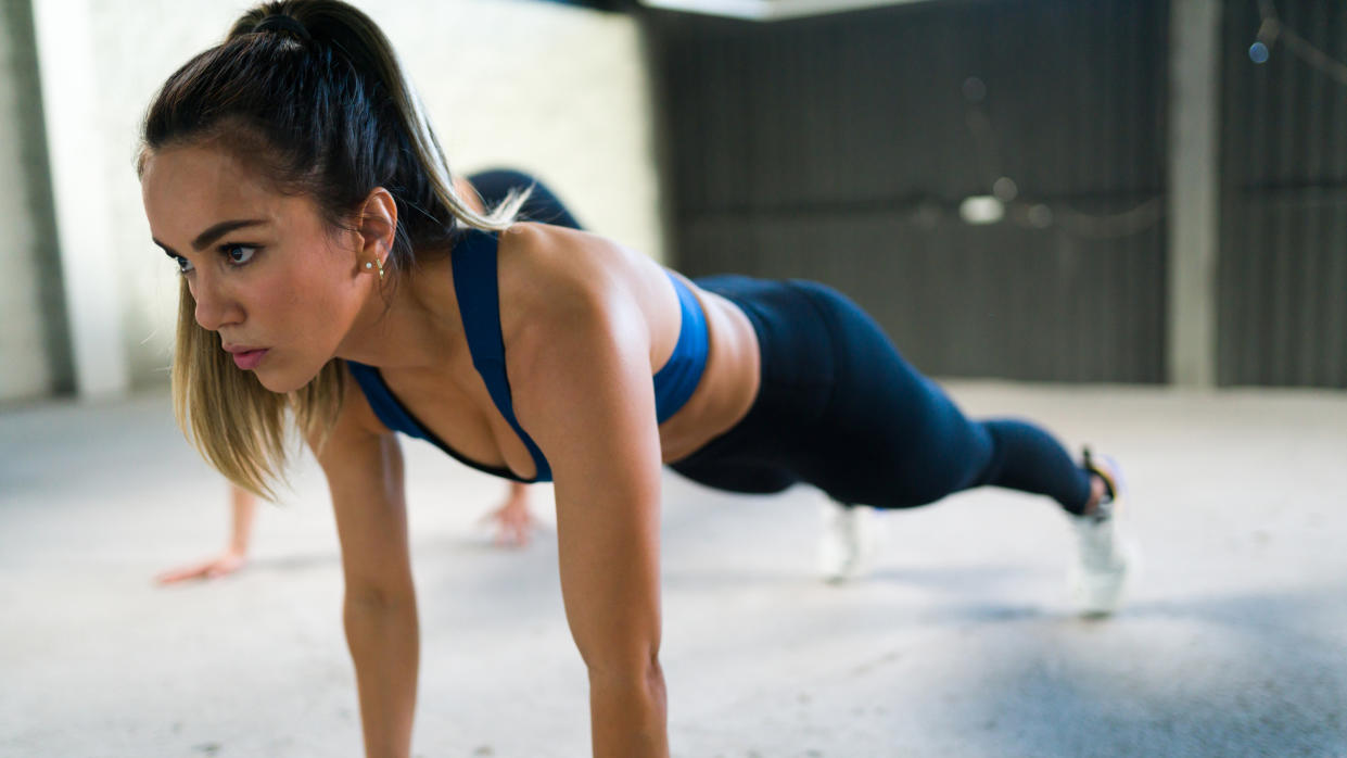  A photo of a woman performing a plank. 