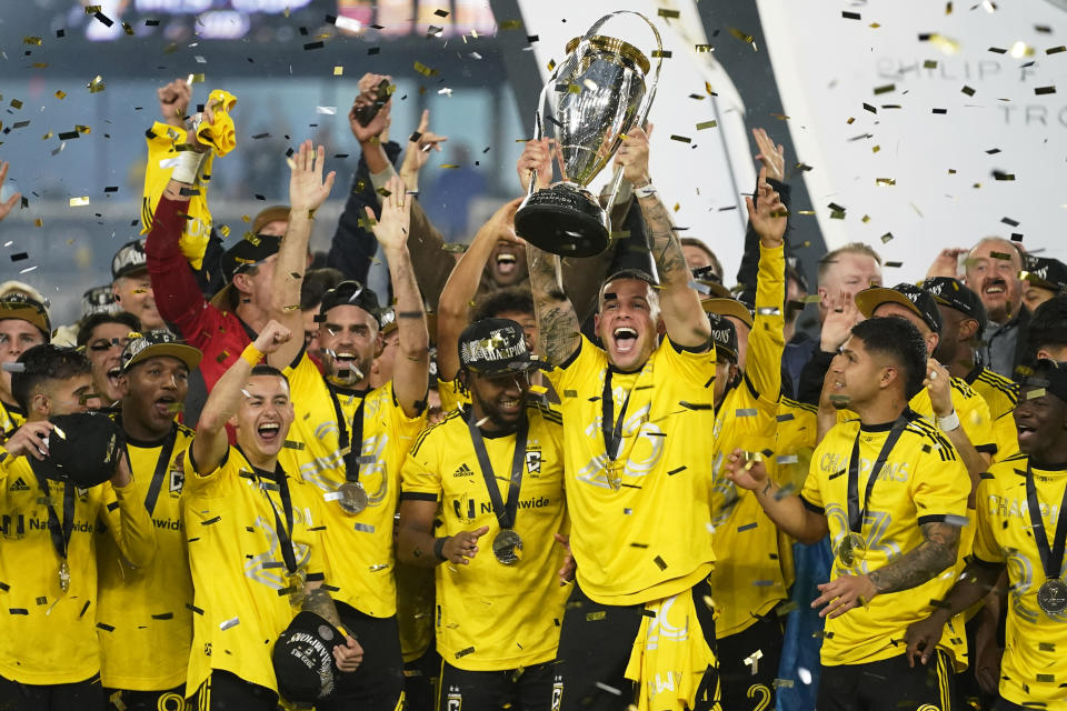 RETRANSMITTING TO CORRECT TEAM TO LOS ANGELES FC - Columbus Crew players celebrate as Christian Ramírez holds up the trophy after defeating Los Angeles FC to win the MLS soccer championship match, Saturday, Dec. 9, 2023, in Columbus, Ohio. (AP Photo/Sue Ogrocki)
