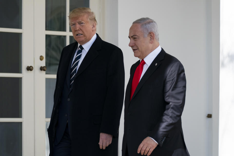 President Donald Trump and Israeli Prime Minister Benjamin Netanyahu walk to a meeting in the Oval Office of the White House, Monday, Jan. 27, 2020, in Washington. (AP Photo/ Evan Vucci)