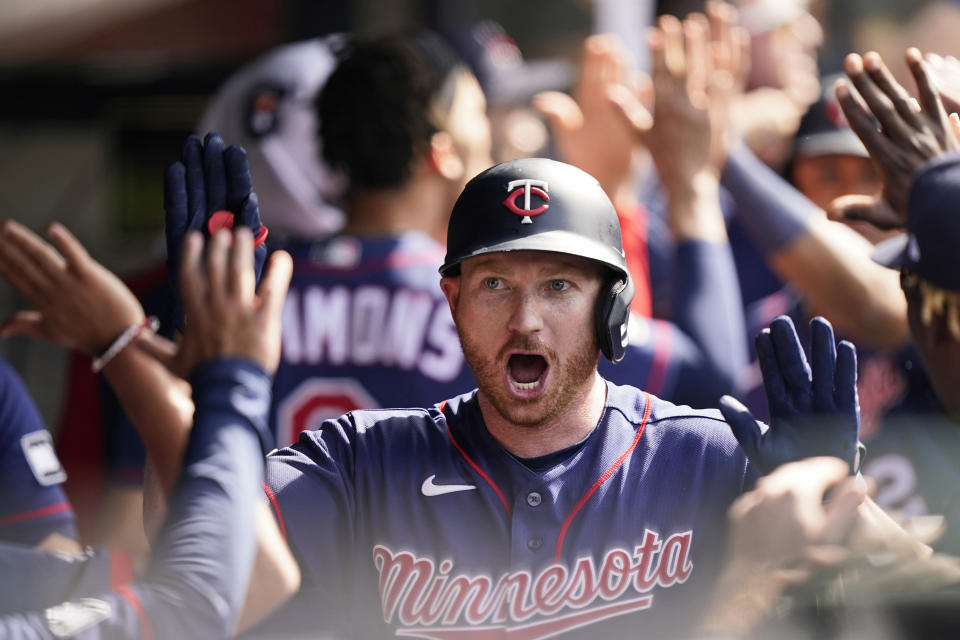 Minnesota Twins' Kyle Garlick celebrates with teammates after he hit a three-run home run in the tenth inning of a baseball game against the Cleveland Indians, Sunday, May 23, 2021, in Cleveland. (AP Photo/Tony Dejak)