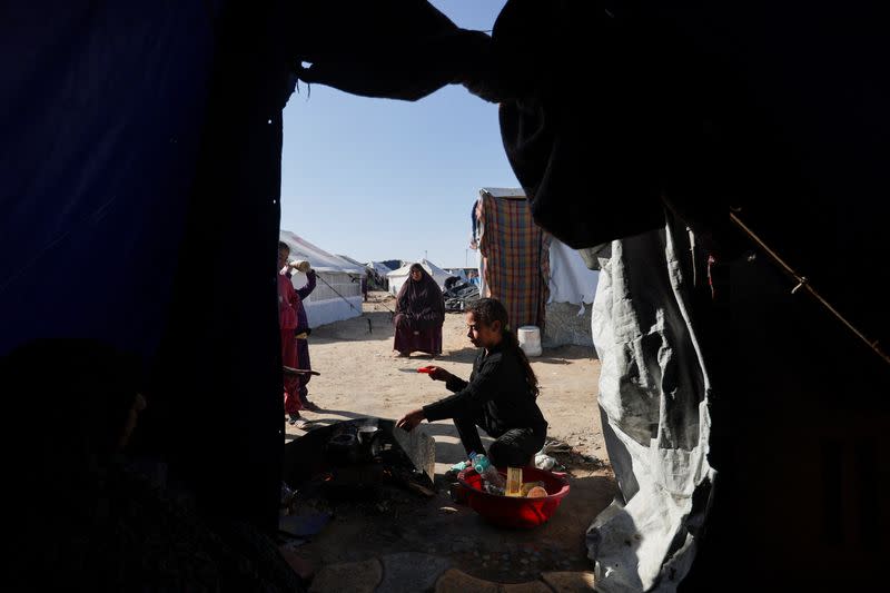 Displaced Palestinians, who fled their houses due to Israeli strikes, shelter in a tent camp in Rafah