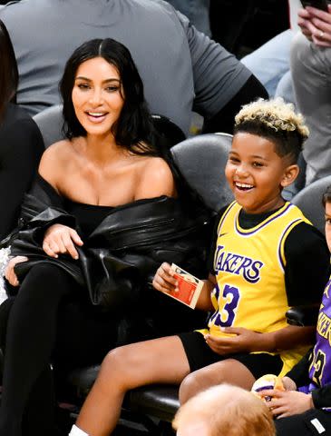 <p>Allen Berezovsky/Getty</p> Kim Kardashian and Saint at the Los Angeles Lakers