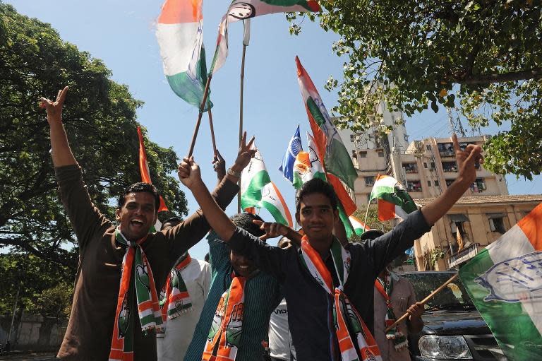 Supporters of Indian Congress party candidate Milind Deora shout slogans during a roadshow in Mumbai, April 12, 2014