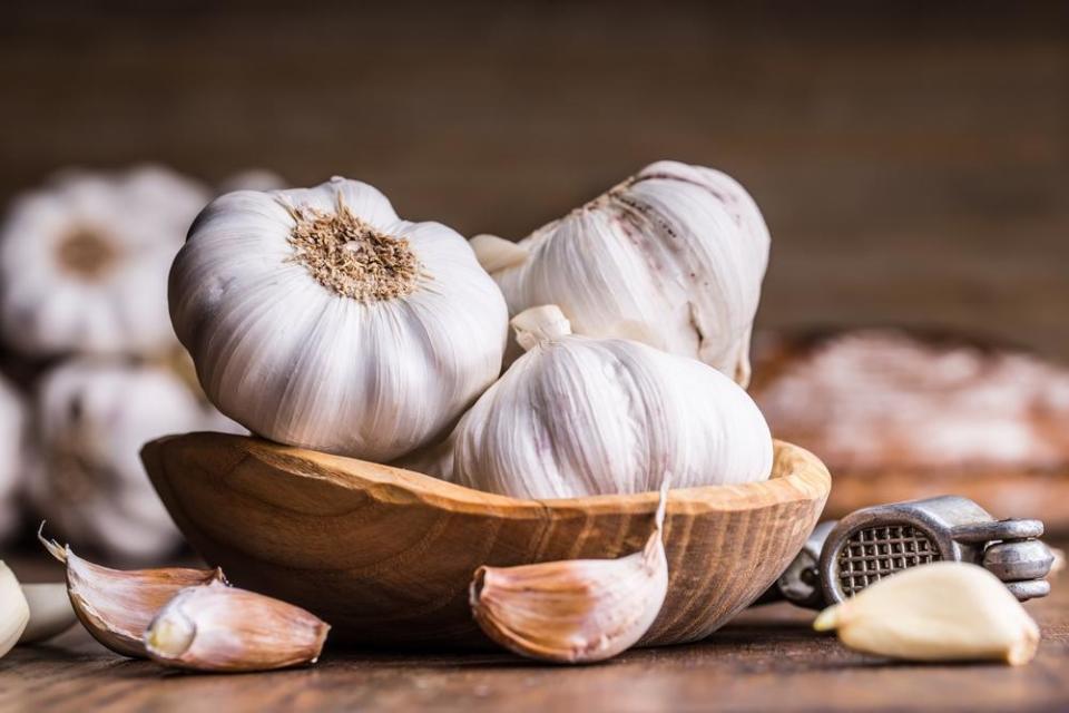 <p>You should always buy whole, unpeeled bulbs of garlic — not only do they taste fresher but they also last longer. (If you buy pre-prepped garlic because you hate taking the skins off, <a href="https://www.thedailymeal.com/cook/garlic-peeling-hack?referrer=yahoo&category=beauty_food&include_utm=1&utm_medium=referral&utm_source=yahoo&utm_campaign=feed" rel="nofollow noopener" target="_blank" data-ylk="slk:try this genius hack that chefs use to peel them;elm:context_link;itc:0;sec:content-canvas" class="link ">try this genius hack that chefs use to peel them</a>.) To tell if your garlic has gone bad, look for dark spots, signs of rot, or patches of green growth. You can also squeeze the garlic and if it feels too soft, it should be thrown away.</p>