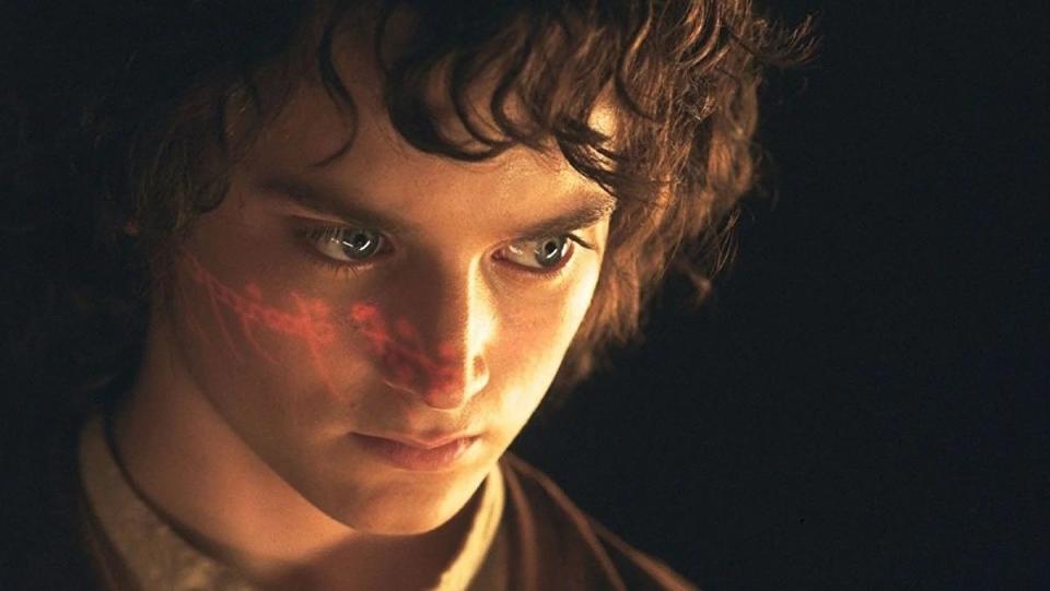 The text of the one ring shines on Frodo Baggins' (Elijah Wood) face in The Lord of the Rings: The Fellowship of the Ring.